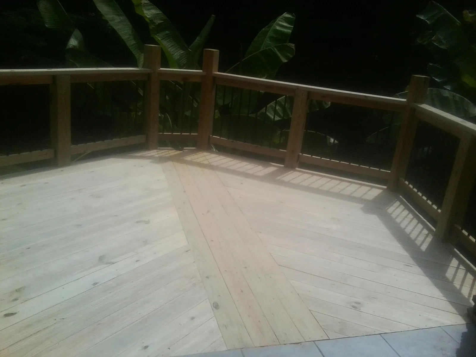 New wood deck and railing built off the back of a home in Somersworth