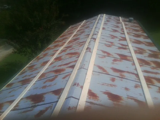 Rusted metal roof panels with new wood purlins before replacement — Storm Damage Roof Repair in Somersworth by Roofing Brothers