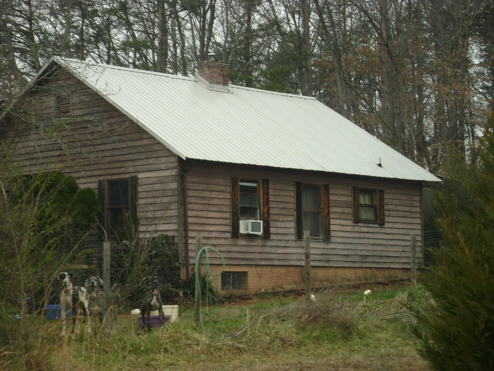 White metal roof on an old wood sided farmhouse, from a Metal Roof Installation job in Somersworth